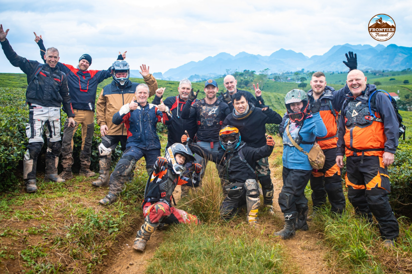 Group of riders from Frontier Travel Vietnam exploring winding mountain roads in Northern Vietnam.